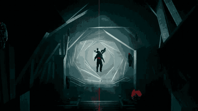 a man is standing in the middle of a tunnel with a red light shining on him