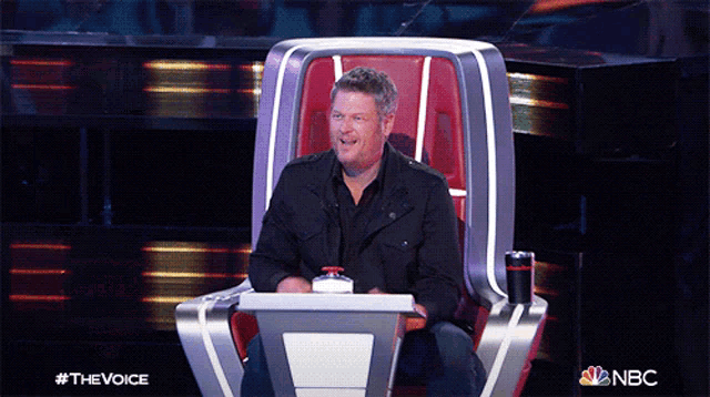 a man sitting in a chair with a nbc logo on the bottom right