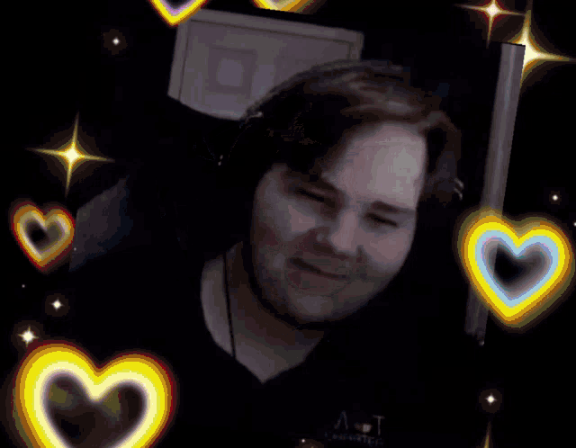 a man wearing headphones is surrounded by hearts .