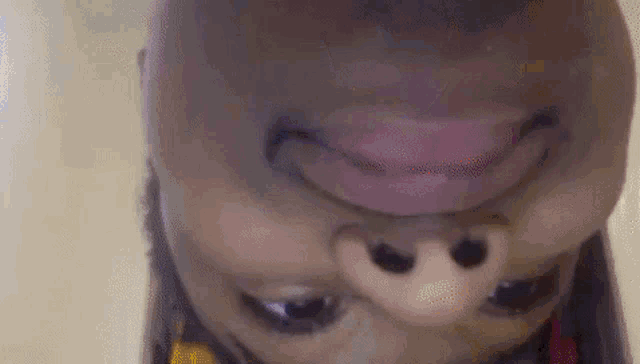 a close up of a person 's face with their mouth open and a smile on their face .