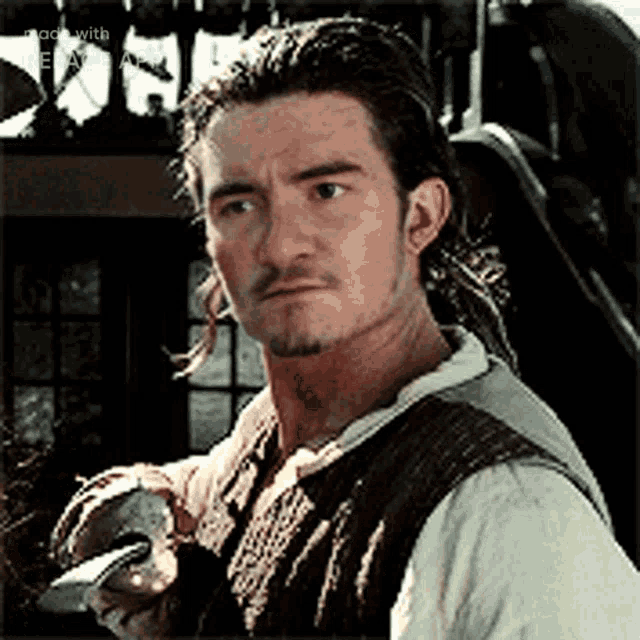 a man with a beard is holding a sword in his hand