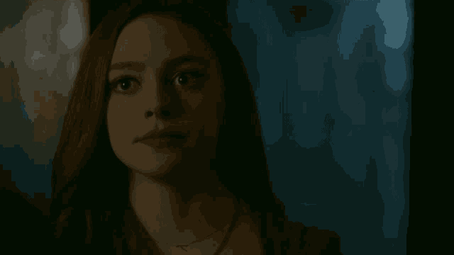 a close up of a woman 's face in the dark