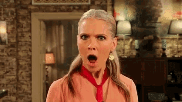 a woman with a surprised look on her face wears a red tie