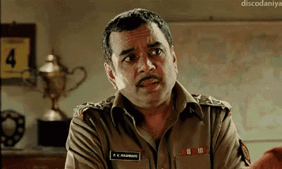 a man in a police uniform is making a funny face in front of a wall with a number 4 on it .