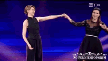 laura & paola performing on a stage in front of a crowd