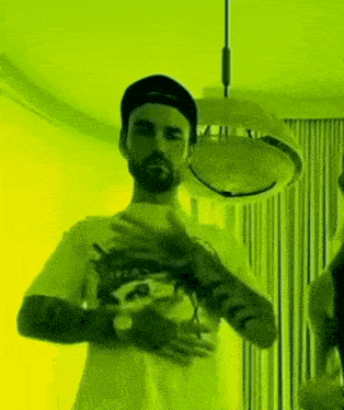 a man with a beard wearing a yellow shirt that says peace on it