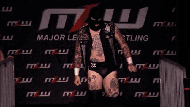 a wrestler named brody king is standing in front of a banner that says fusion