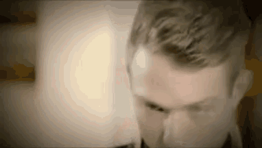 a close up of a man 's face with his eyes closed and his hair visible .