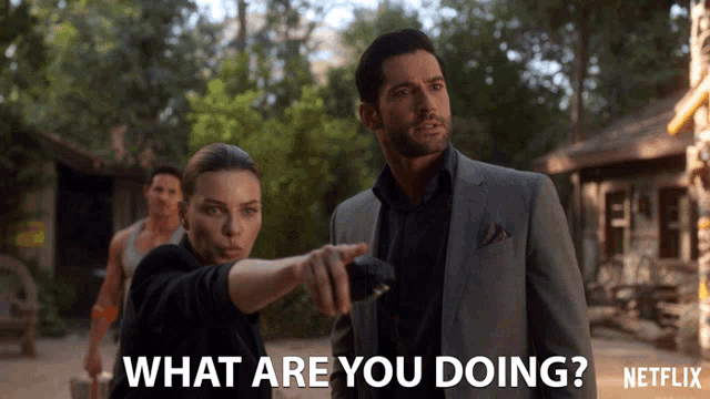 a man in a suit and a woman pointing at him with the words what are you doing netflix written below them