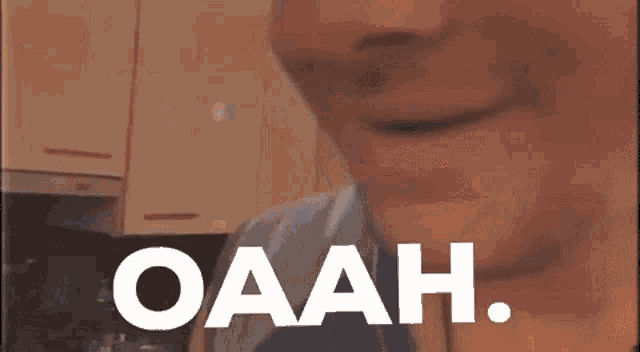 a man wearing a hat with the word oaah on the bottom