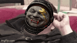 a person laying on a bed with a helmet on their head that looks like a vampire with blood coming out of his mouth