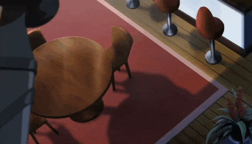 a room with a round table and chairs in it