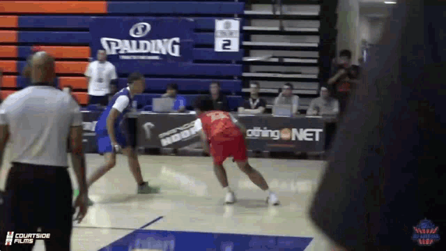 a basketball game is being played in front of a spalding logo