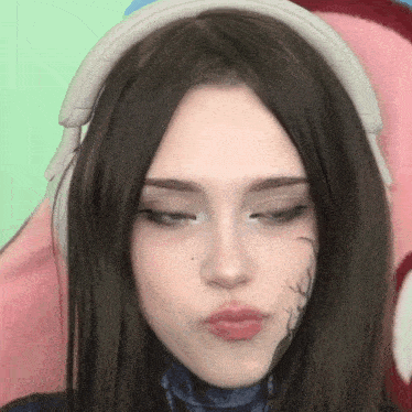a close up of a woman wearing headphones and making a funny face