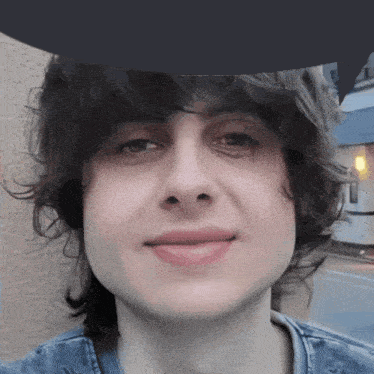 a close up of a person 's face with a hat on their head