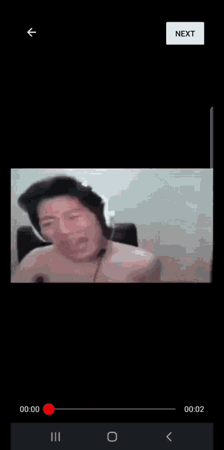 a video of a man wearing headphones is playing on a phone .