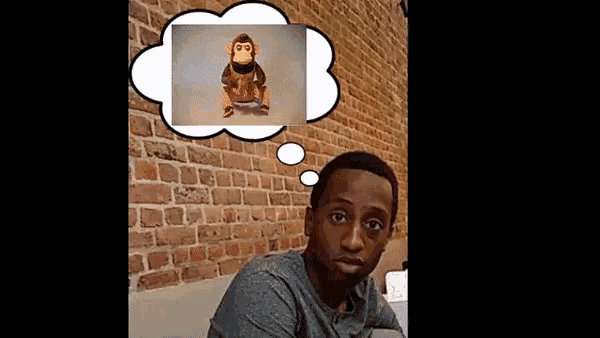 a man sitting in front of a brick wall with a thought bubble with a picture of a monkey