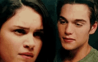 a man and a woman are looking at each other with their eyes closed