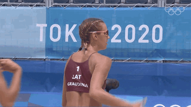 a woman in a red top with the number 1 on it
