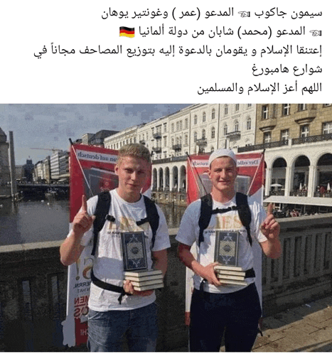 two men standing next to each other holding books in front of a sign that says ' marlboro '