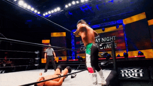 a wrestling match is taking place in front of a sign that says sunday night