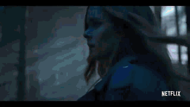 a netflix advertisement shows a nun standing in a dark room