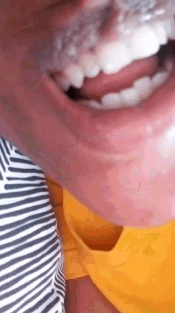 a close up of a person 's mouth with their tongue sticking out
