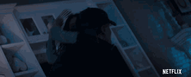 a netflix advertisement shows a man and woman hugging in a dark room