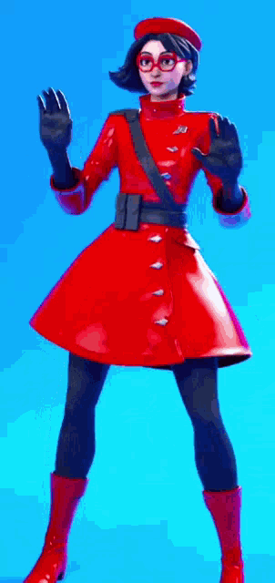 a woman wearing a red coat and glasses is standing in front of a blue background .