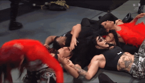 a group of people laying on the floor with a w logo on the bottom left