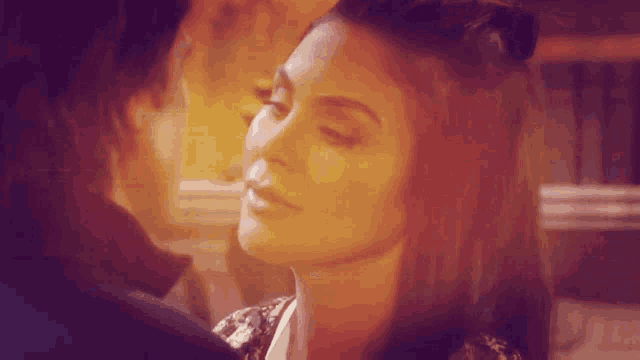 a man and a woman are looking into each others eyes .