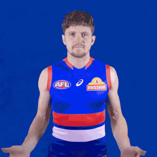 a man wearing an afl jersey with mission written on the front