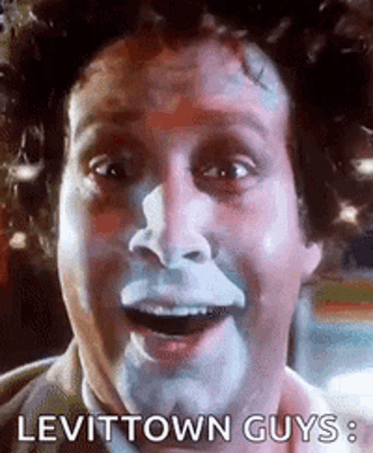 a close up of a man with white paint on his face .
