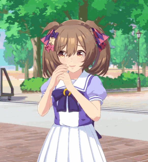 a girl with pigtails and a bow in her hair stands in a park