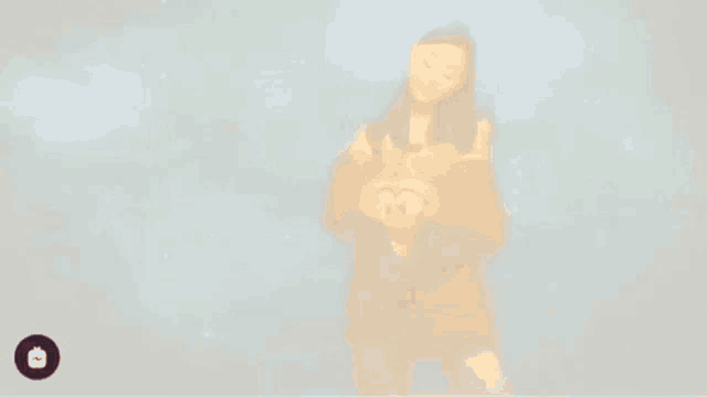 ariana grande is making a heart shape with her hands in front of a blue sky .