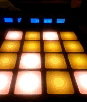a dance floor with yellow and pink squares and circles on it