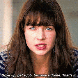 a close up of a woman 's face with the words " grow up get a job become a drone that 's it "