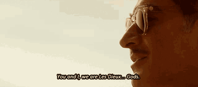 a close up of a man wearing sunglasses with the words you and we are les dieux gods