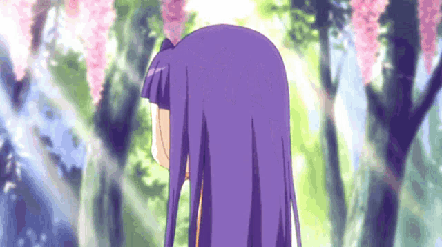 a girl with purple hair is standing in a forest with trees and flowers in the background .