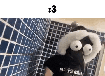 a person is taking a selfie in a bathroom with a stuffed animal on their face .