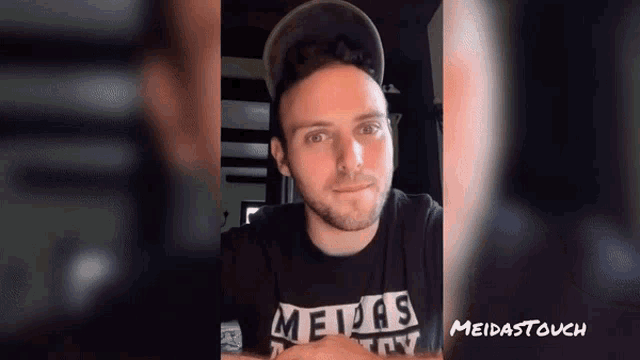 a man wearing a shirt that says meidas on it
