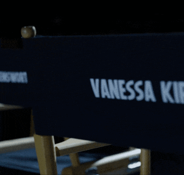 a blue director 's chair with vanessa kirby written on it