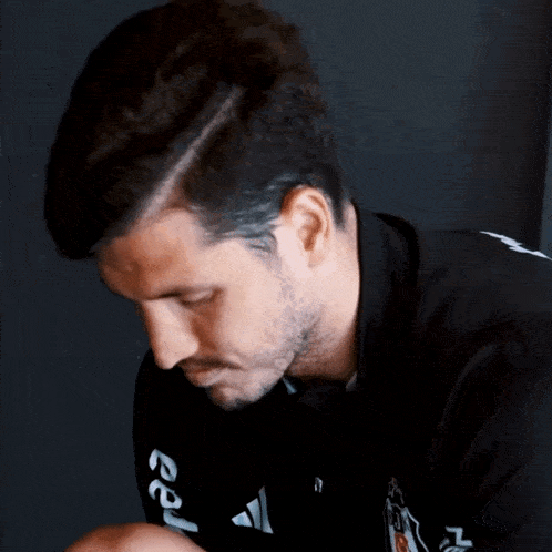 a man wearing a black shirt with the letters ep on the sleeve