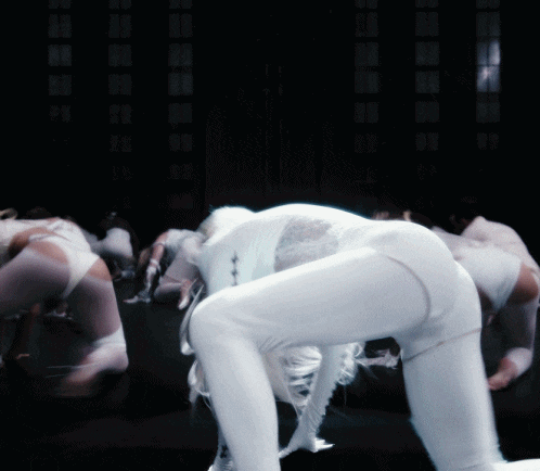 a blurred image of a woman in white pants