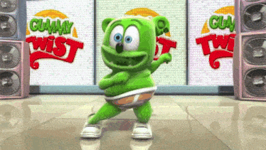 a green gummy bear is dancing in front of a wall that says gummy twist