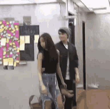 a man and a woman are dancing in a room .
