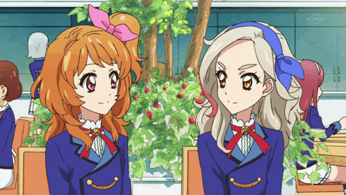 two anime girls are sitting next to each other in front of a tv screen that says tv tokyo
