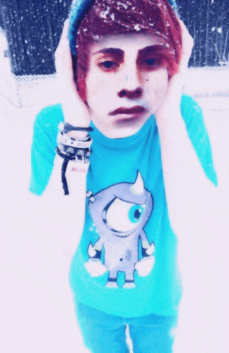 a boy in a blue shirt with a monster on it