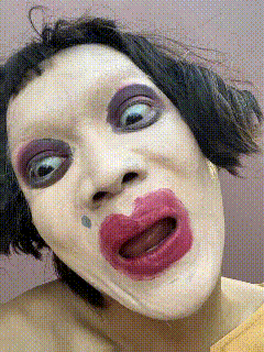a close up of a woman 's face with makeup on