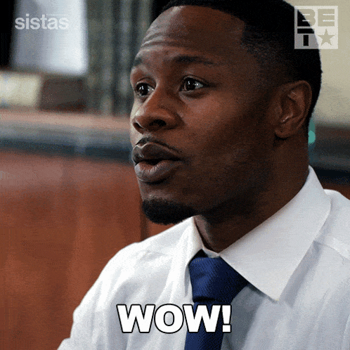 a man in a white shirt and blue tie has the word wow on his chest